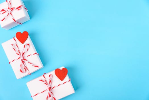 Valentine's day Concept, flat lay top view, White Gift Box and Red Heart on Blue background with copy space for your text