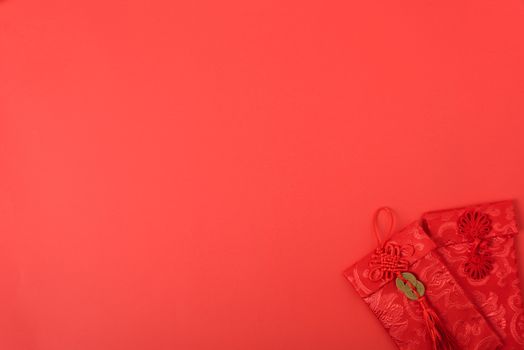 Chinese new year festival concept, flat lay top view, Happy Chinese new year with Red envelope (Character "FU" means fortune, blessing, wealth) on red background with copy space for your text