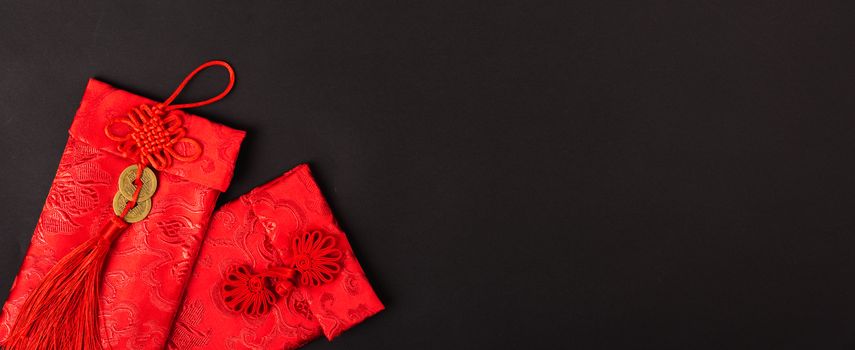 Chinese new year festival concept, flat lay top view, Happy Chinese new year with Red envelope (Character "FU" means fortune, blessing, wealth) on black background with copy space for your text