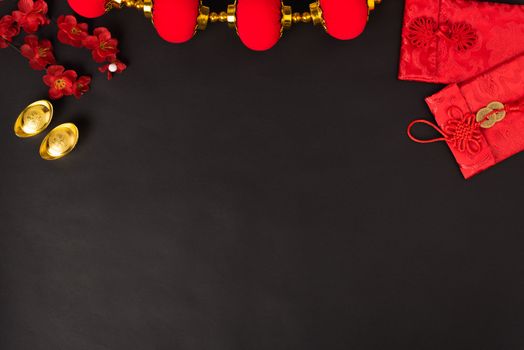 Chinese new year concept, flat lay top view, Happy Chinese new year with Red envelope and gold ingot (Character "FU" means fortune, blessing, wealth) on black background with copy space for your text