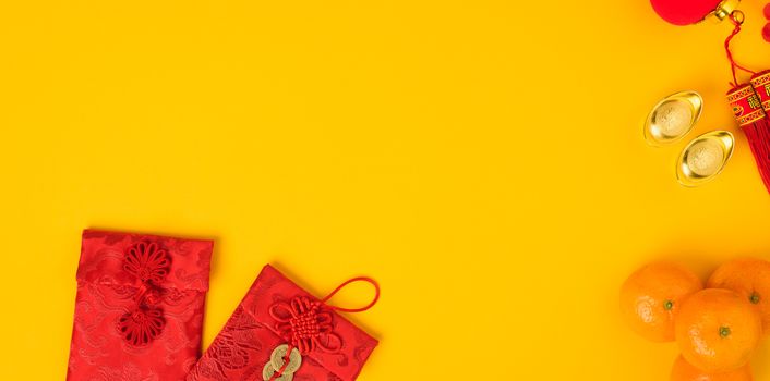 Chinese new year festival concept, flat lay top view, Happy Chinese new year with Red envelope and gold ingot (Character "FU" means fortune, blessing) on yellow background with copy space for text