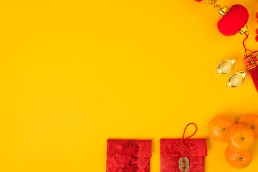 Chinese new year festival concept, flat lay top view, Happy Chinese new year with Red envelope and gold ingot (Character "FU" means fortune, blessing) on yellow background with copy space for text