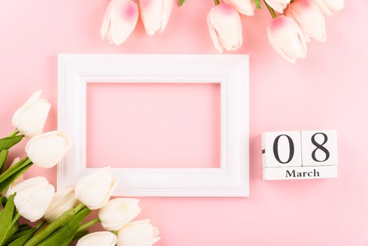 Happy Women's Day, Mother's Day concept. top view flat lay Tulip flower and photo frame on pink background, copy space for your text