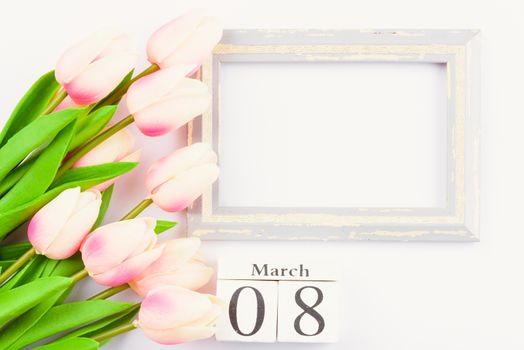 Happy Women's Day, Mother's Day and Valentine's Day concept. top view flat lay Tulip flower and photo frame on white background, copy space for your text