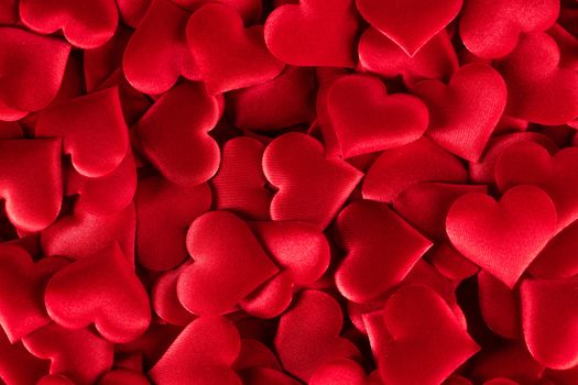 Valentine's day many red silk hearts background, love concept