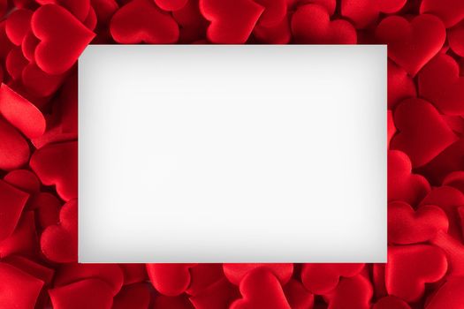 Valentine's day white card on many red silk hearts background , border frame with white card with copy space, love concept
