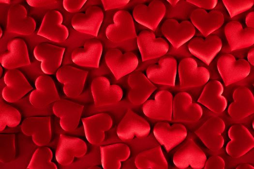 Valentine's day many red silk hearts background, love concept