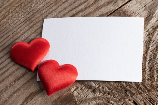 Valentine's day white blank paper greeting card and red silk hearts, background border frame with copy space, love concept