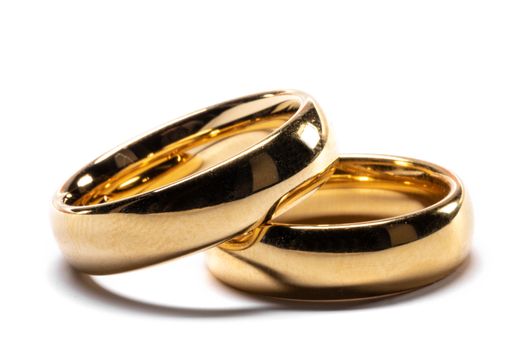 Couple of gold wedding rings isolated on white background