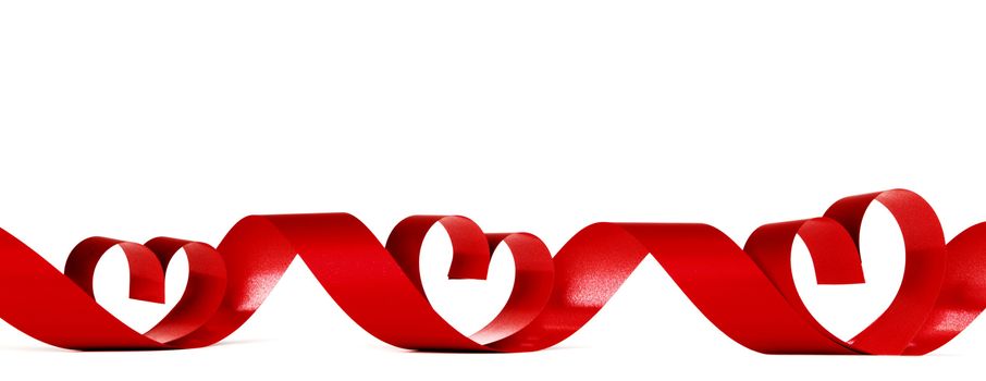 Heart shaped red ribbon isolated on white background