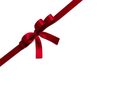 Red satin ribbon bow isolated on white background