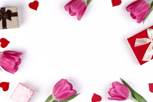Pink tulip flowers gifts red hearts and gifts composition isolated on white background top view with copy space. Valentine's day, birthday, wedding, Mother's day concept. Copy space