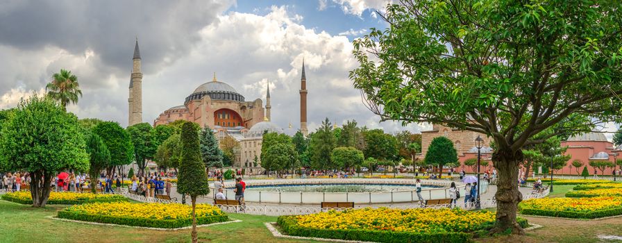 Istambul, Turkey – 07.12.2019. The Sultan Ahmad Maydan water fountain with the Hagia Sophia museum in background on a cloudy summer day, Istanbul, Turkey