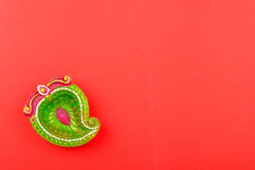 Happy Diwali Day, Flat lay top view Colorful Clay Diya lamps on red background and copy space for your text