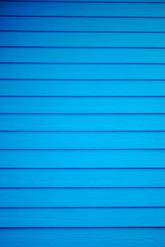Blue painted wooden house wall. Blue plank background.