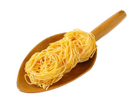 bundles of spaghetti pasta in wooden scoop