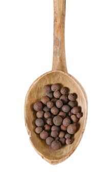 spoon of whole allspice berries on white background