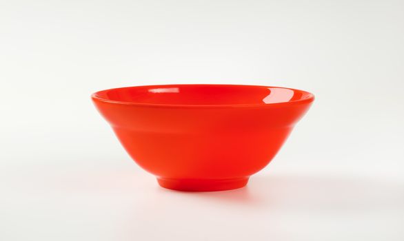 Empty deep red plastic bowl