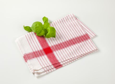 Striped tea towel an fresh basil leaves