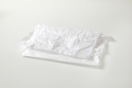 Creased sheet of white wax coated butcher paper