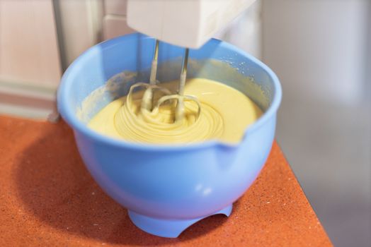 close up mixing biscuit dough with a electric mixer. Shallow deep of field