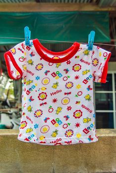 Baby clothes hanging on a clothes lin