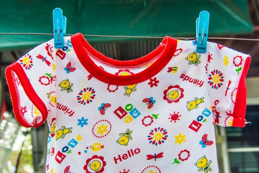 Baby clothes hanging on a clothes lin