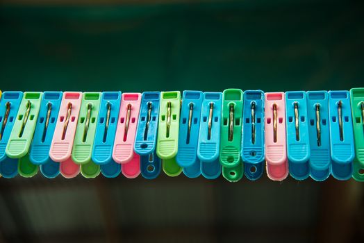 Clothes peg hang on a cord.