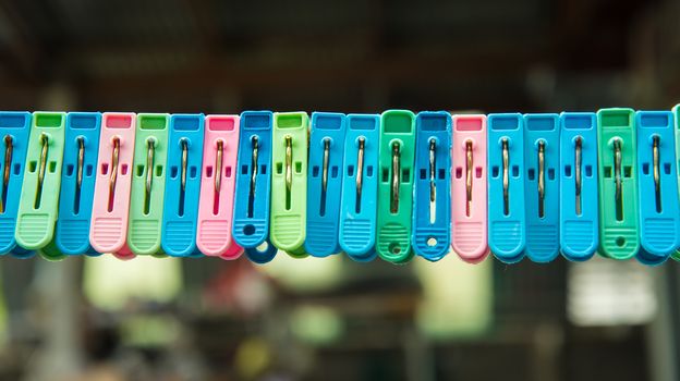 Clothes peg hang on a cord.