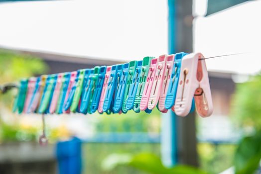 Clothes peg hang on a cord.