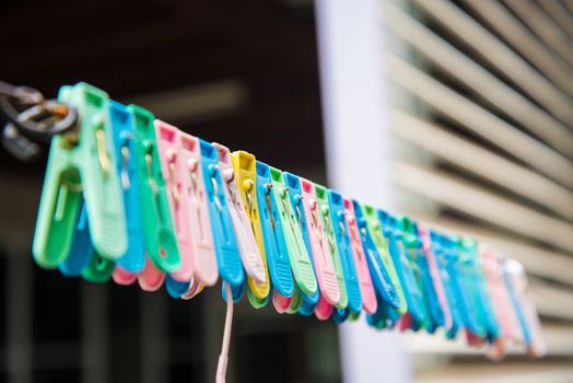 Clothes peg hang on a cord.