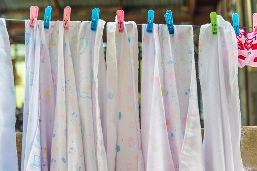 Diaper hanging on a clothes line.