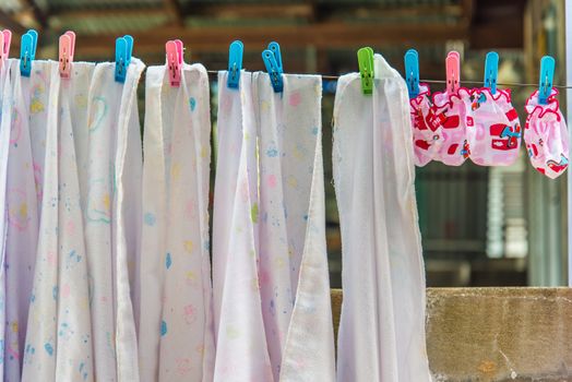 Diaper hanging on a clothes line.