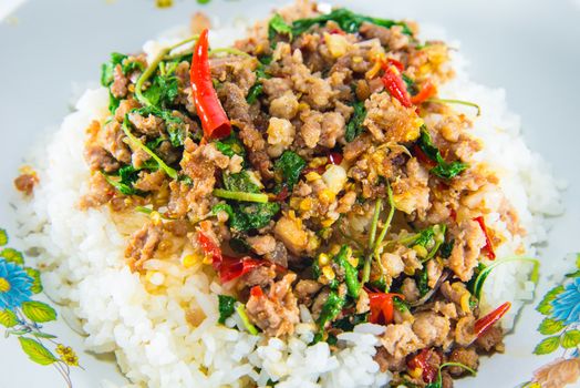 Fried pork and basil on white background.
