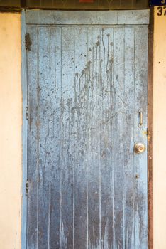 Oil slick on old wooden door for background.