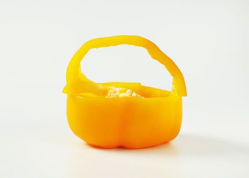 Half and slice of yellow bell pepper forming a basket