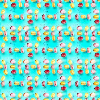 Abstract seamless pattern with flying colored macaroons, holiday concept