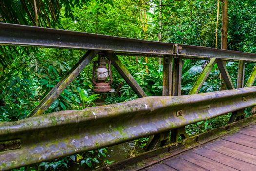 old rusty vintage lantern on a bridge in a jungle scenery, Architecture in nature