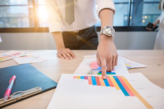 Business people are meeting and graphing business growth on a desk