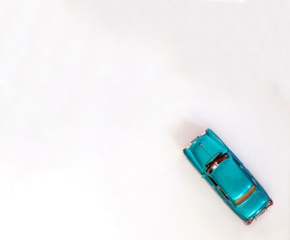 Children's toy car on white background top view with copying space.