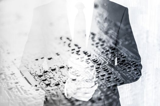 Businessman wearing fashionable classic navy blue suit against pc motherboard chip photo layer.