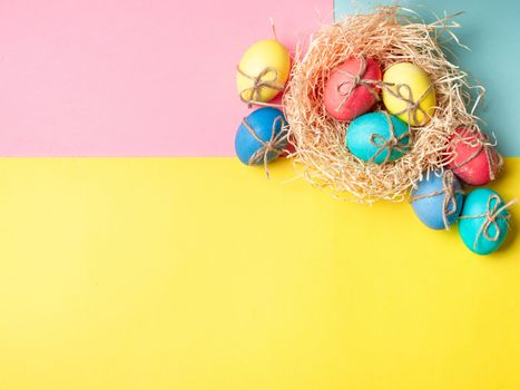 Easter concept. Colorful eggs on bright colorful background with copy space for text. Top down view or flat lay