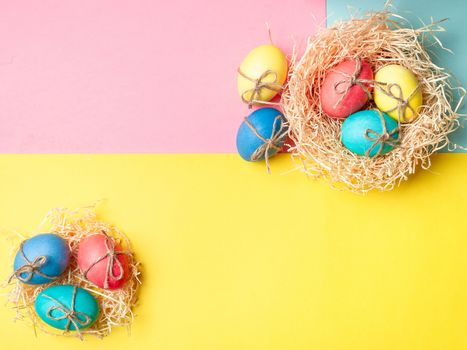 Easter concept. Colorful eggs on bright colorful background with copy space for text. Top down view or flat lay