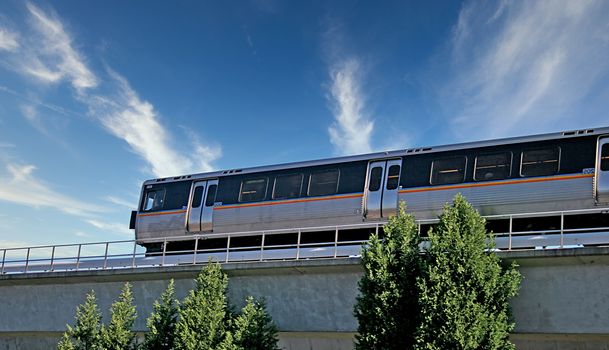 A mass transit subway train speeding into a station