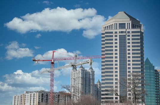 Modern office towers and construction cranes building new ones