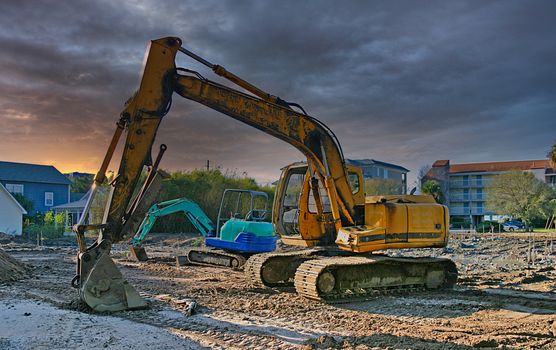 A yellow and blue front end loader on a job site