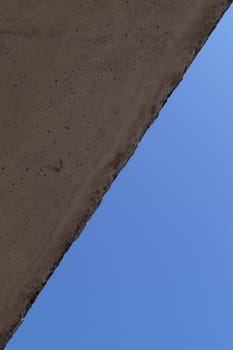 The wall and blue sky crossed the line in corners. Abstract photo.
