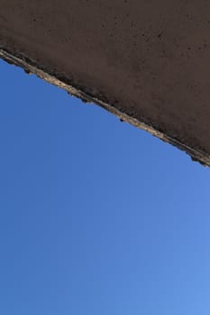 The wall and blue sky crossed the line in corners. Abstract photo.