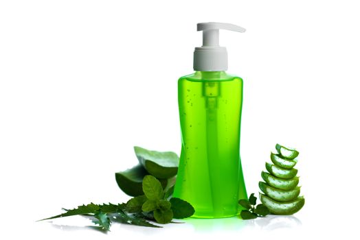 Bottle of liquid soap or cream or face wash dispensers with aloe vera, neem and basil leaf isolated on white background.