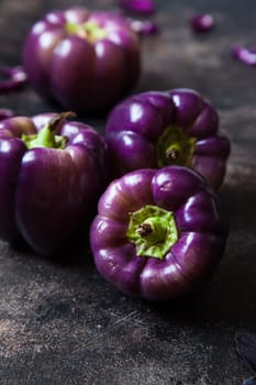 Set of purple peppers on table